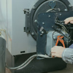 technician servicing a boiler
